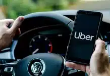 uber driver holds smartphone in car